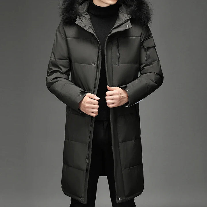 Man wearing army green hooded down coat with fur trim, front view