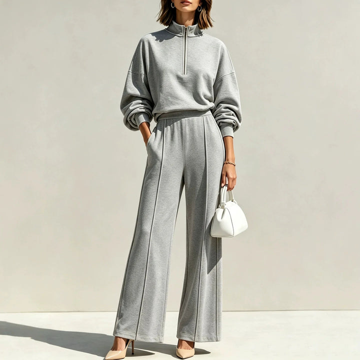 Woman wearing gray half zip pullover and wide leg pants set