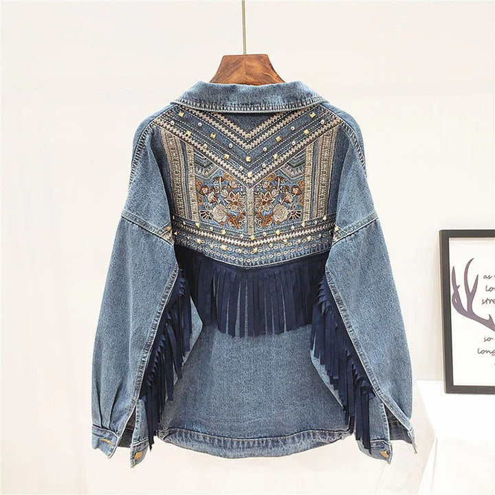 Black denim jacket back view with embroidered yoke and fringe trim