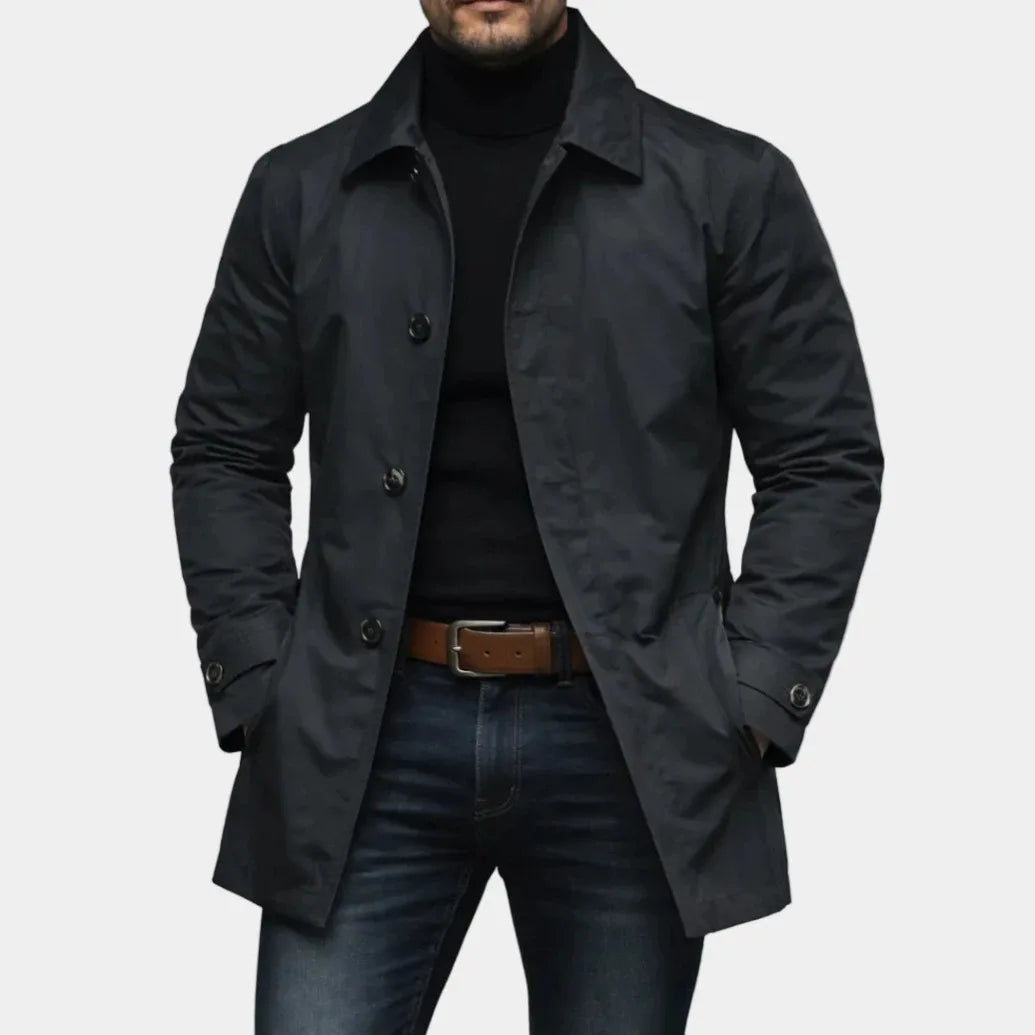Man wearing black mac-style trench coat with button front