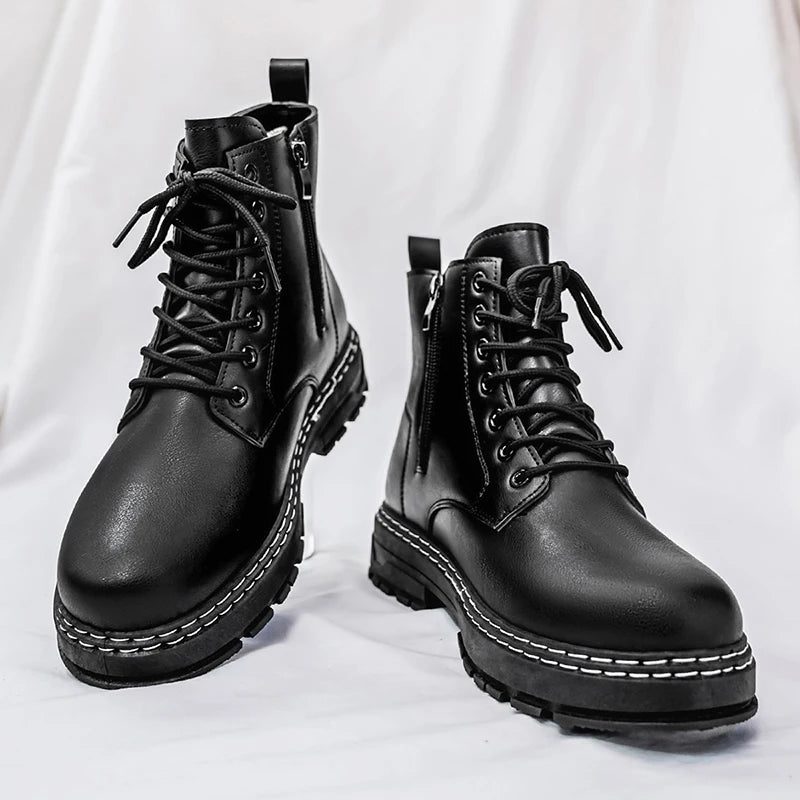 Pair of black combat boots front angle on surface