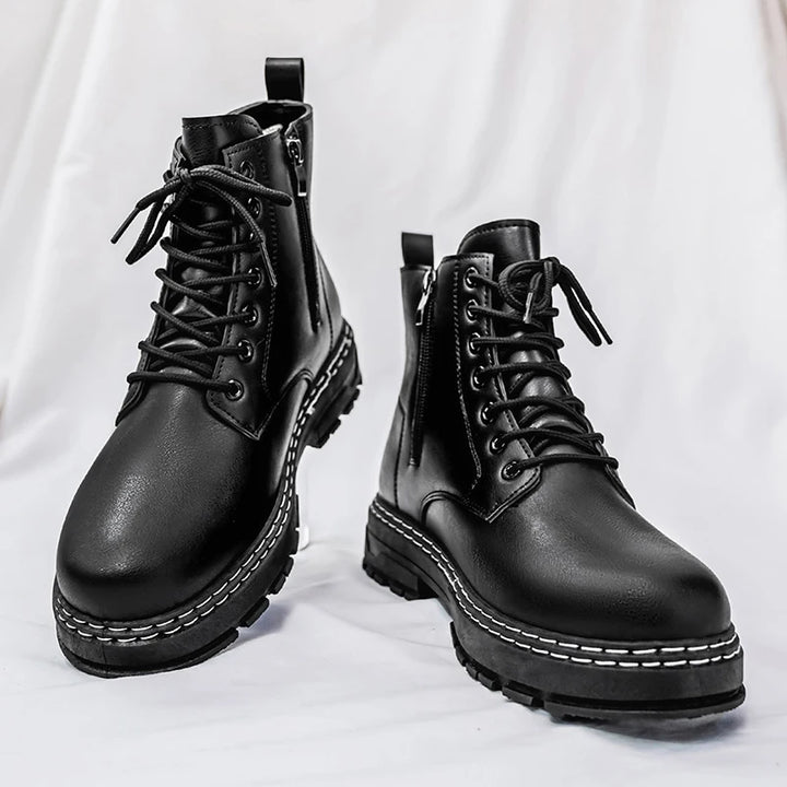 Pair of black combat boots front angle on surface