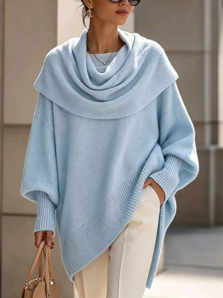 Woman wearing light blue draped scarf collar poncho sweater