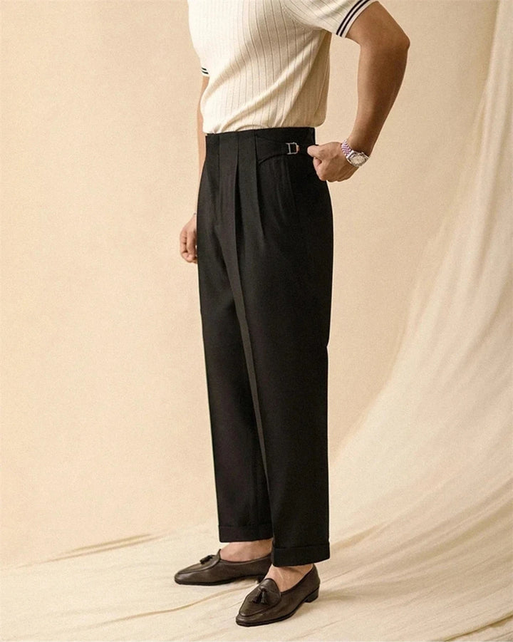 Man wearing black pleated trousers with loafers, side view