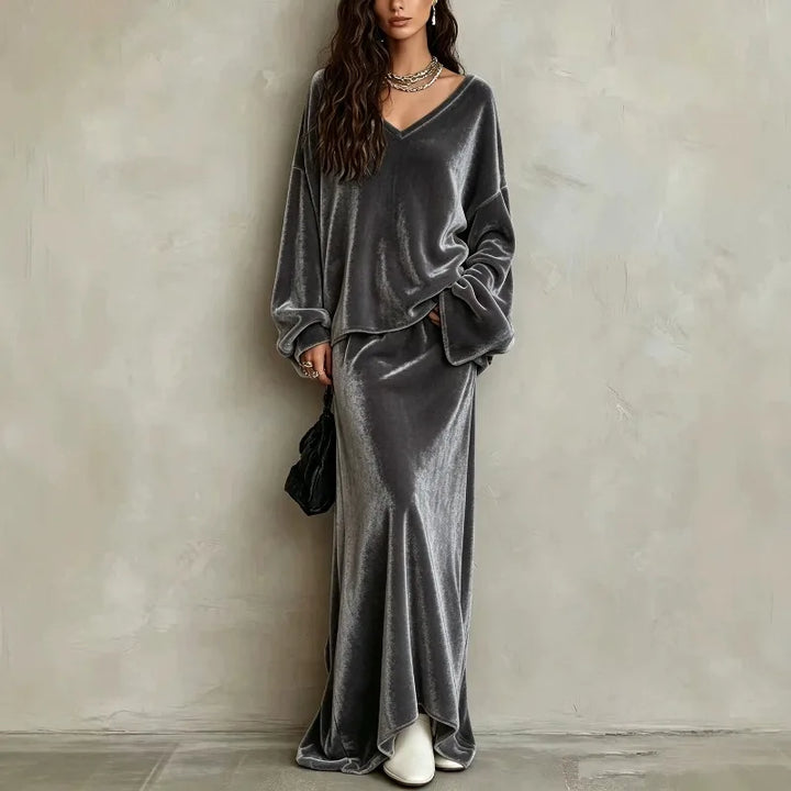 Woman wearing gray velvet V neck pullover and matching maxi skirt set