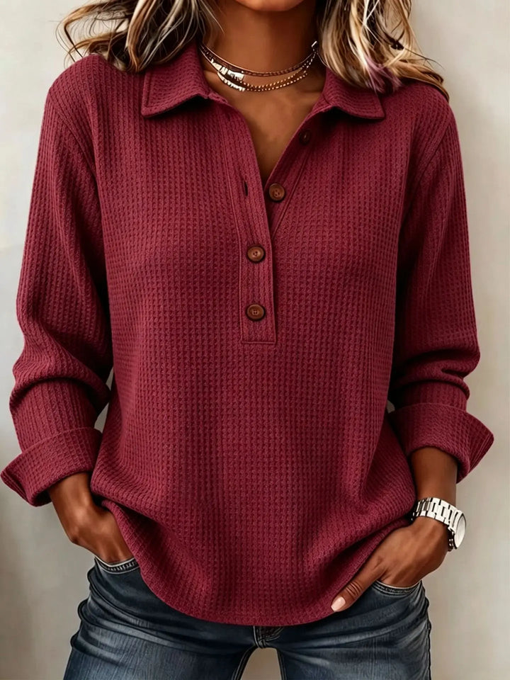 Close up of wine red waffle knit top with button placket