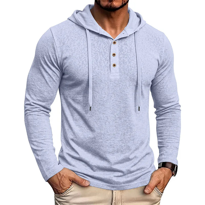Man wearing light blue drawstring hooded pullover with half-button placket, front view