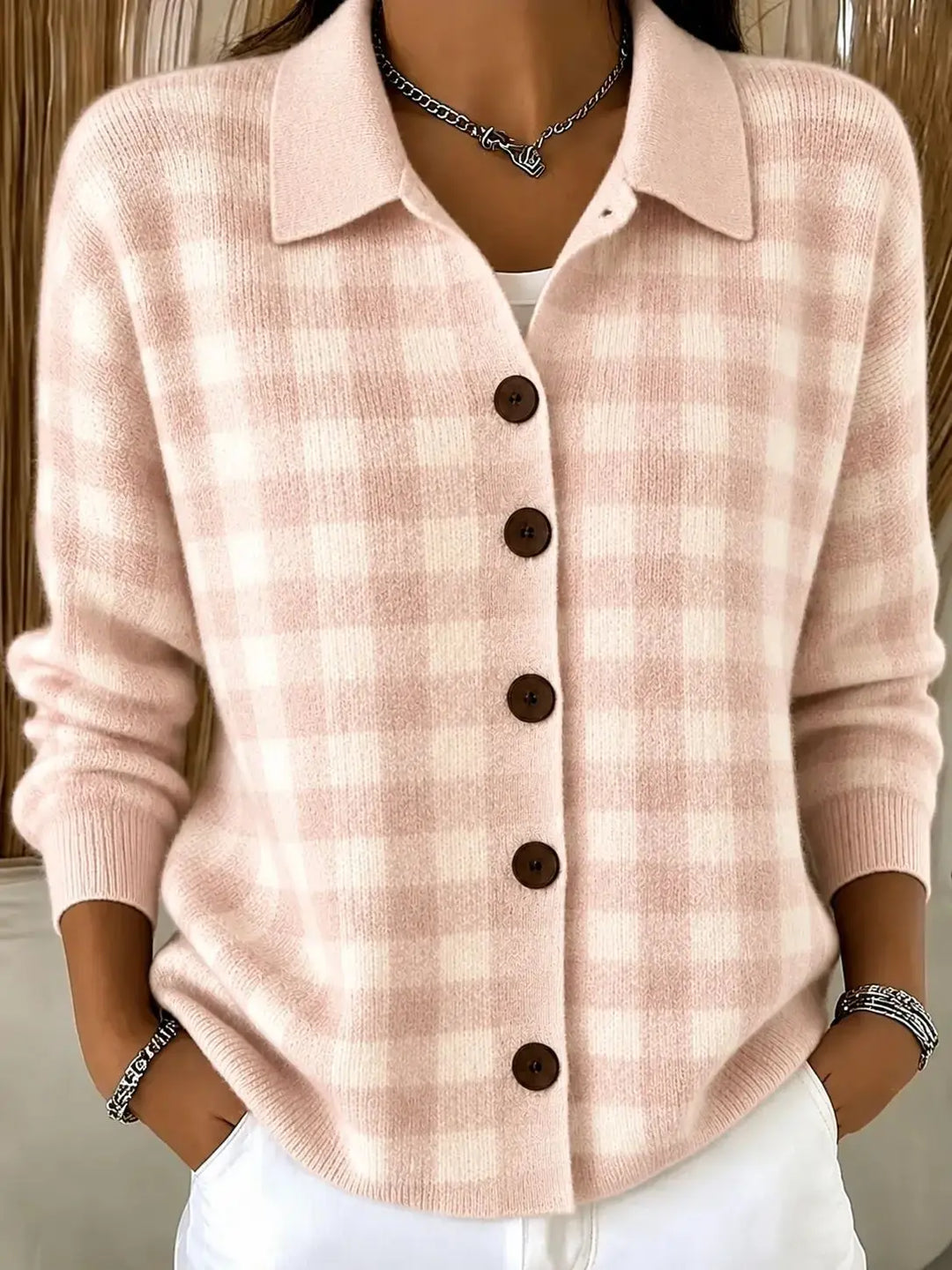 Woman wearing pink gingham knit cardigan with collar and button front