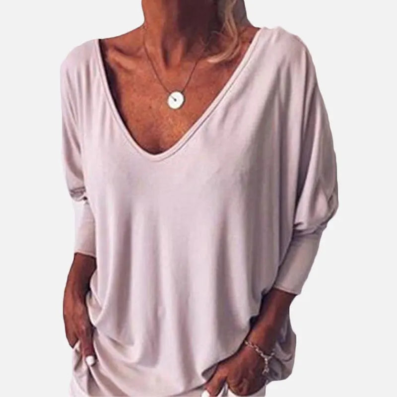 Woman wearing light pink V-neck three-quarter sleeve top, front view