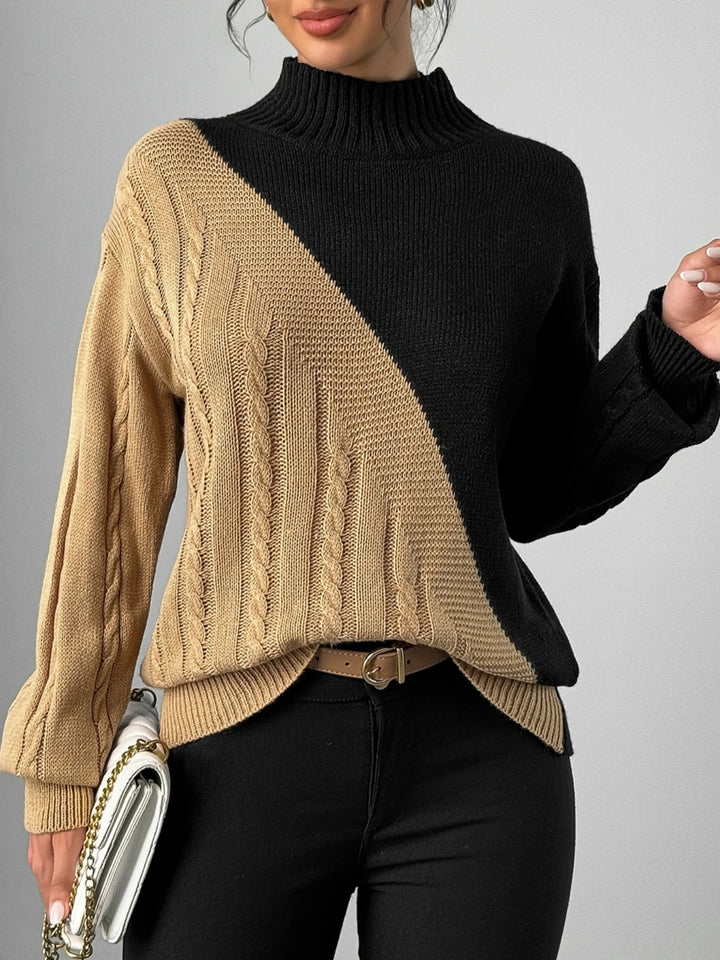 Woman wearing khaki and black color block cable knit mock neck sweater, front view