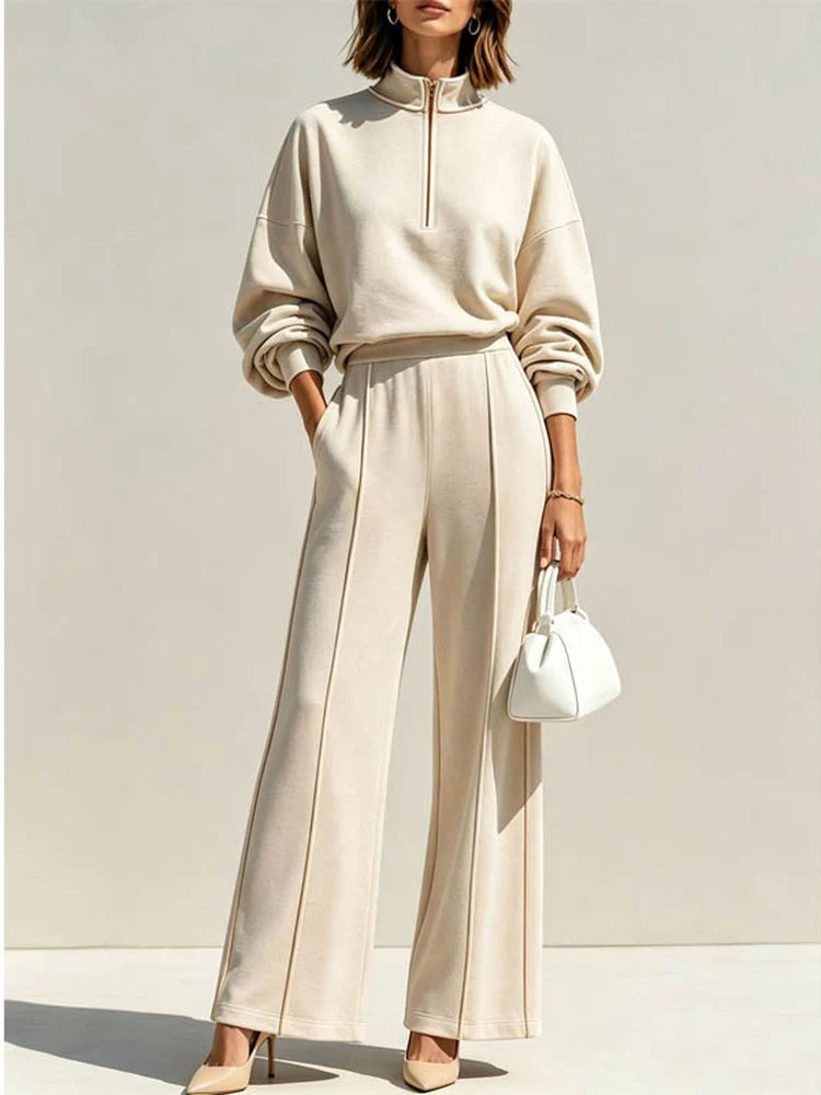 Woman wearing beige quarter zip pullover and wide leg pant set, front view