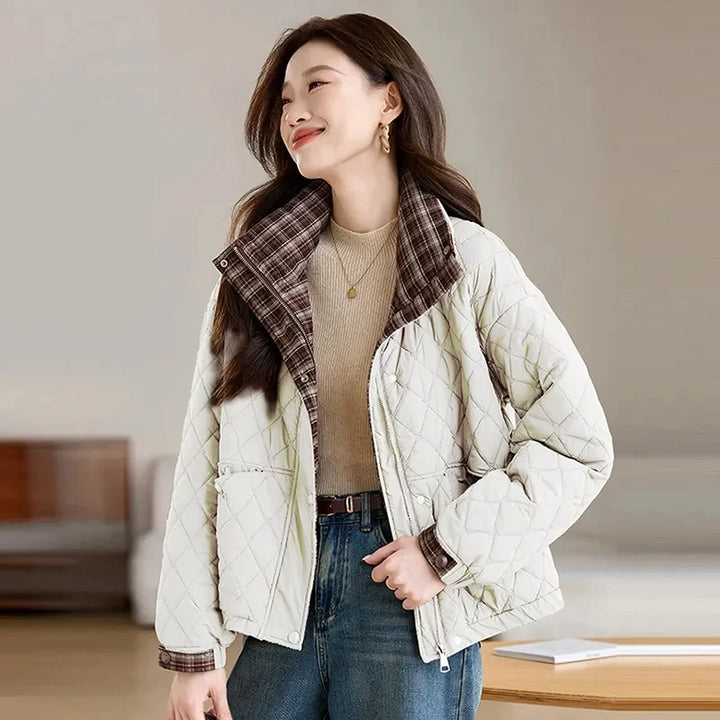 Woman wearing off white quilted puffer jacket with plaid collar