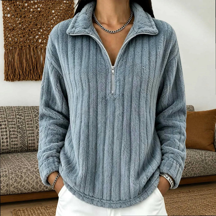Woman wearing gray-blue ribbed quarter-zip pullover