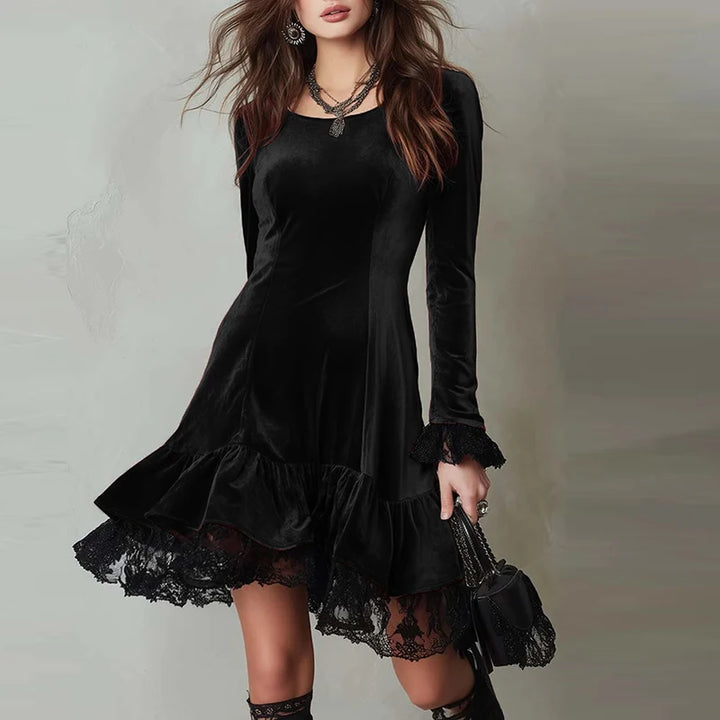 Woman wearing black velvet mini dress with lace trim