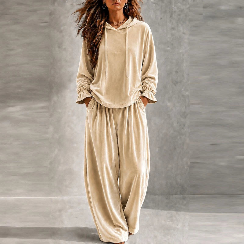 Woman wearing beige velvet hooded tracksuit with wide leg pants