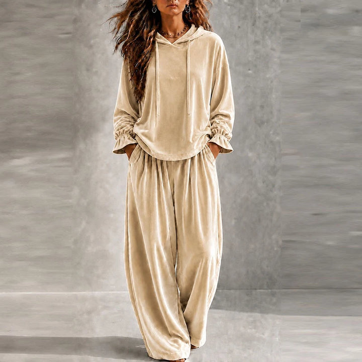 Woman wearing beige velvet hooded tracksuit with wide leg pants
