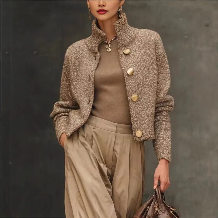 Woman wearing camel bouclé knit cardigan with stand collar and button front