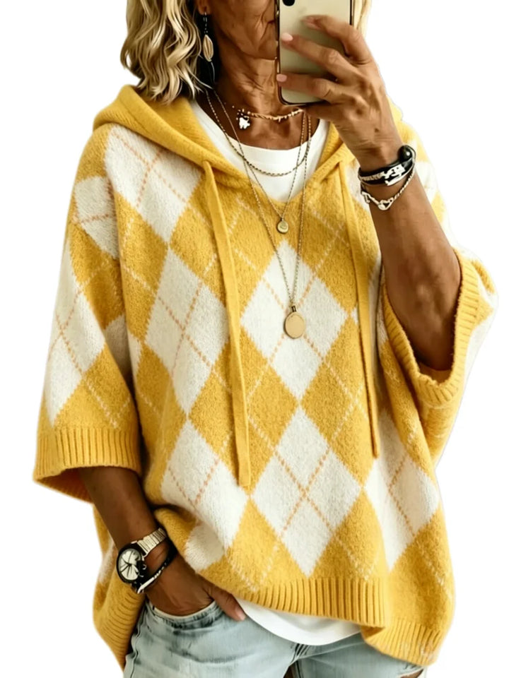 Woman wearing yellow argyle hooded knit sweater, front view
