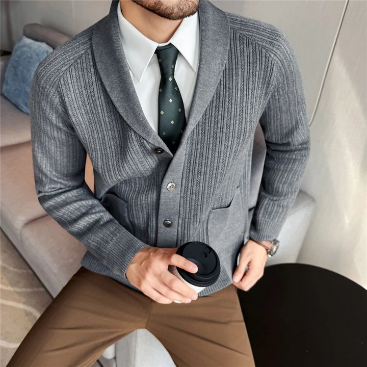 Man wearing gray shawl collar cardigan over white shirt and tie