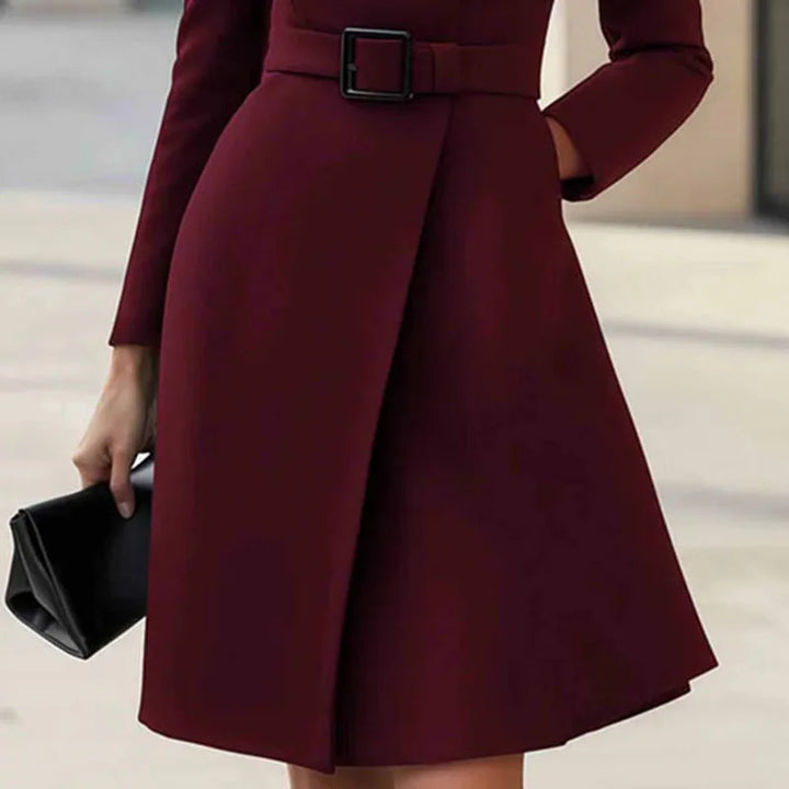 Wine red dress skirt detail showing wrap front hem and belted waist