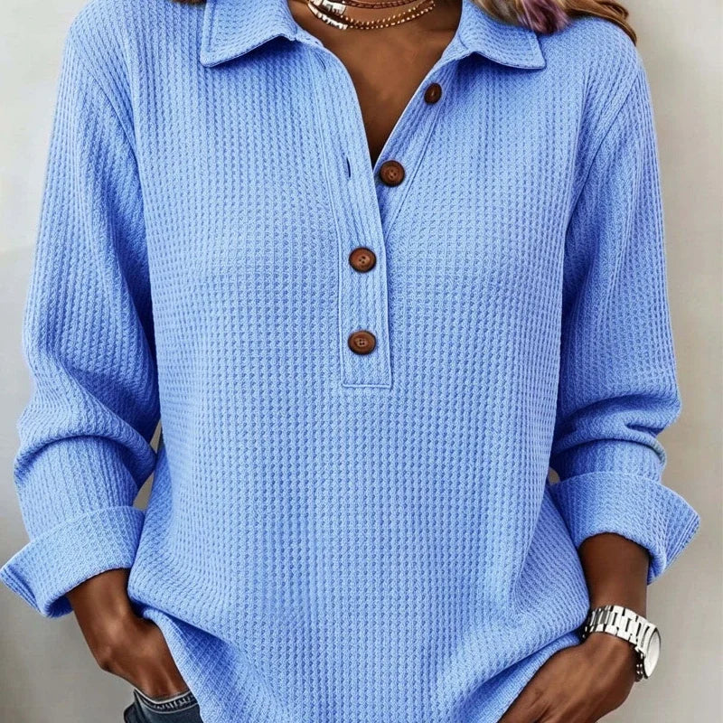 Close up of sky blue waffle knit top with button placket collar