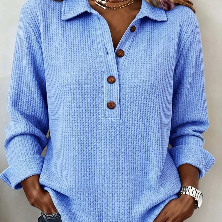 Close up of sky blue waffle knit top with button placket collar