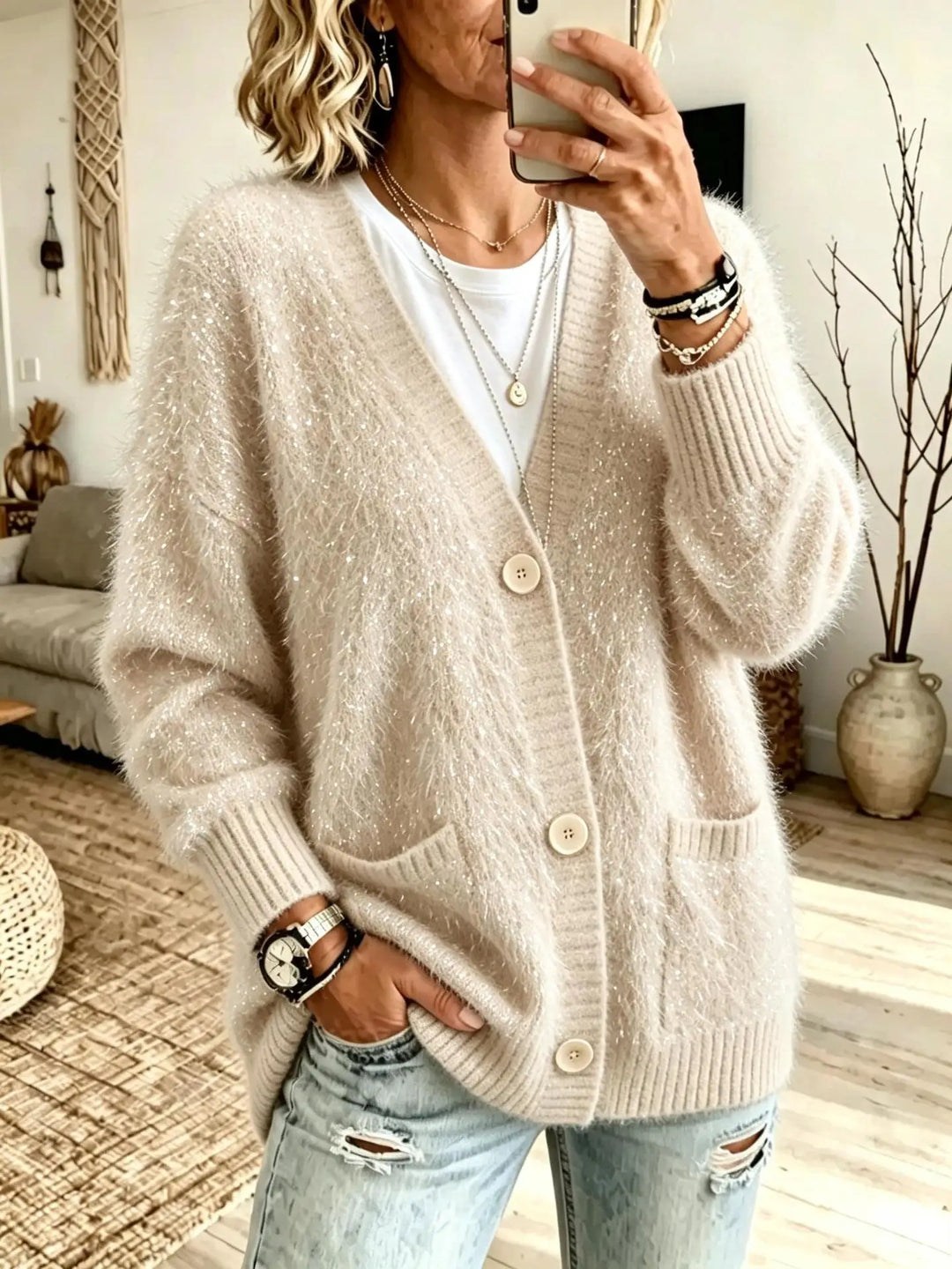 Close up of apricot eyelash-knit cardigan with button closure
