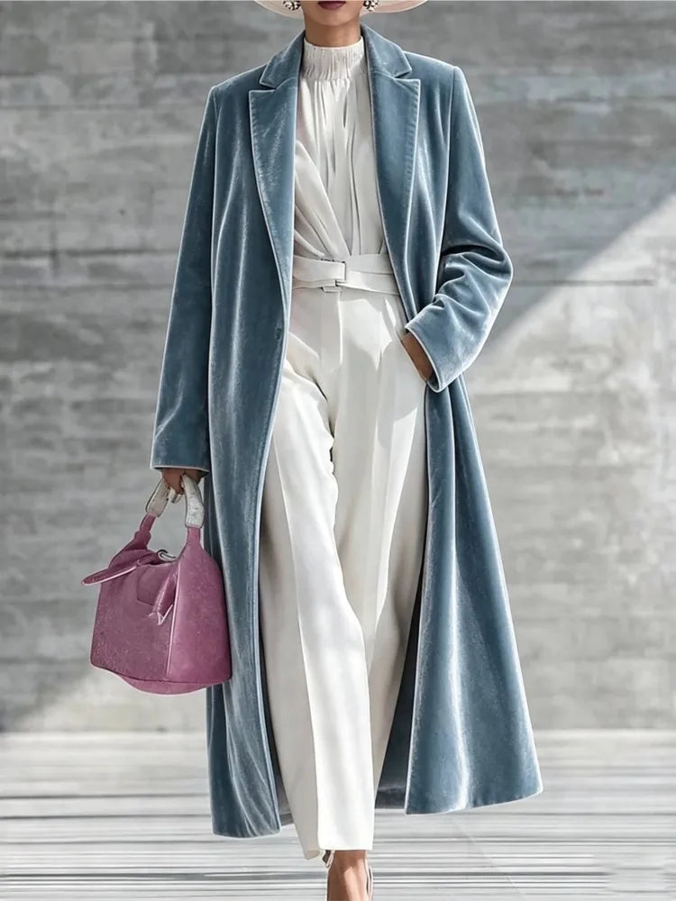 Woman wearing a dusty blue velvet maxi coat with notched lapel