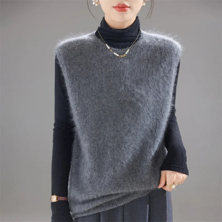 Gray brushed knit sweater vest worn over black turtleneck