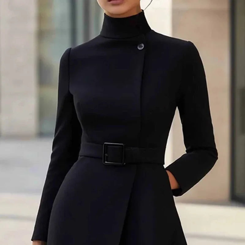 Close-up of black turtleneck dress bodice with button detail and belted waist