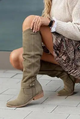 Green suede knee-high slouch boots worn with floral skirt