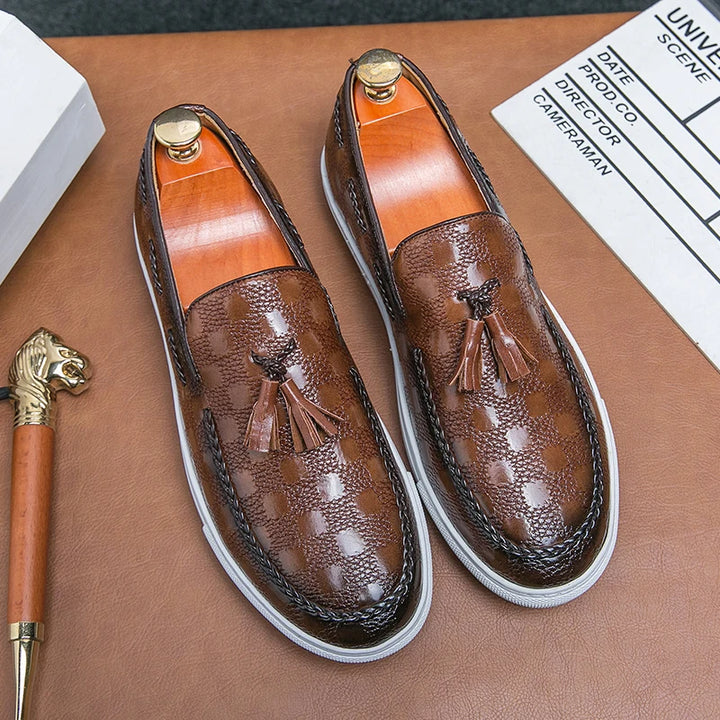 Brown tasseled loafers on shoe trees, top view
