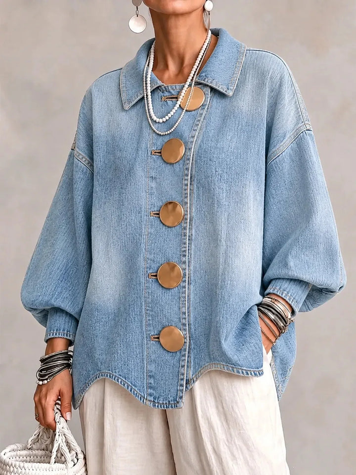 Woman wearing sky blue denim jacket with large gold buttons, front view
