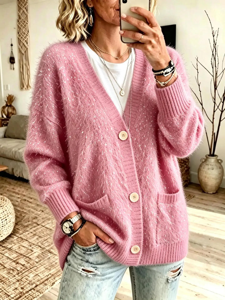 Close up of pink eyelash-knit cardigan with button closure