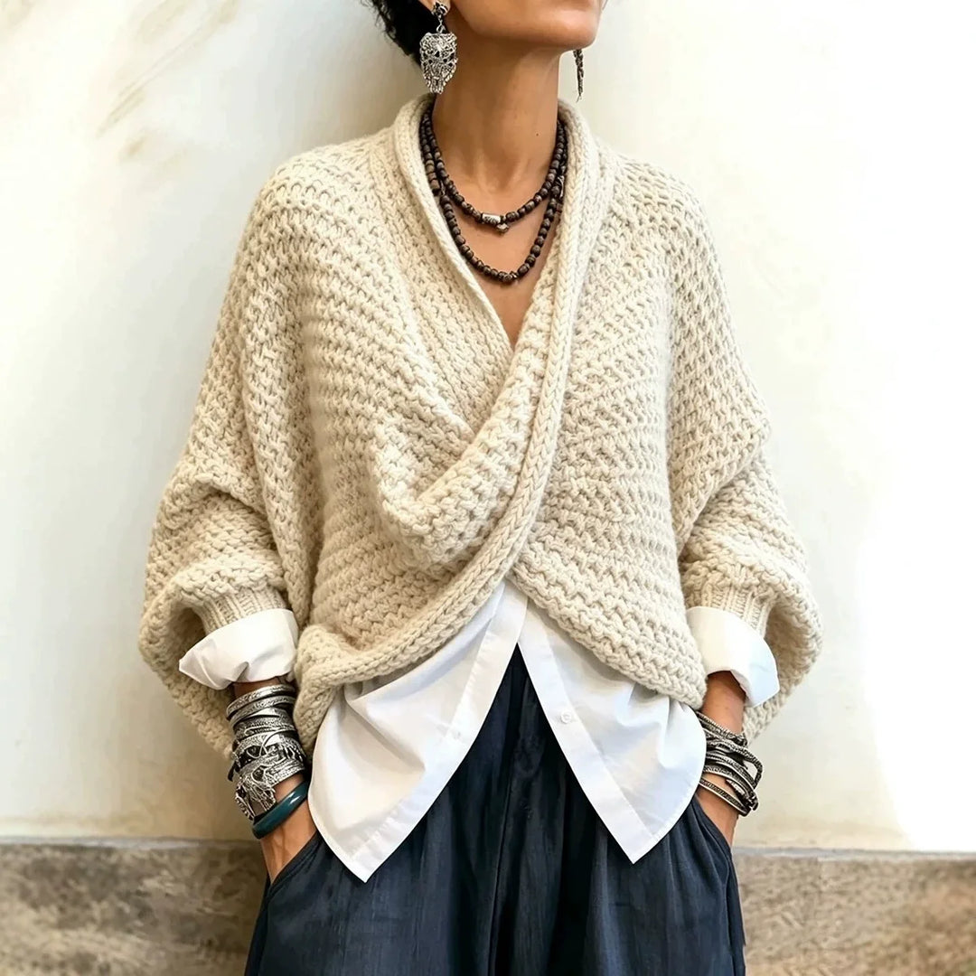 Woman wearing beige wrap front chunky knit cardigan over white shirt