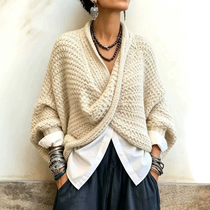 Woman wearing beige wrap front chunky knit cardigan over white shirt