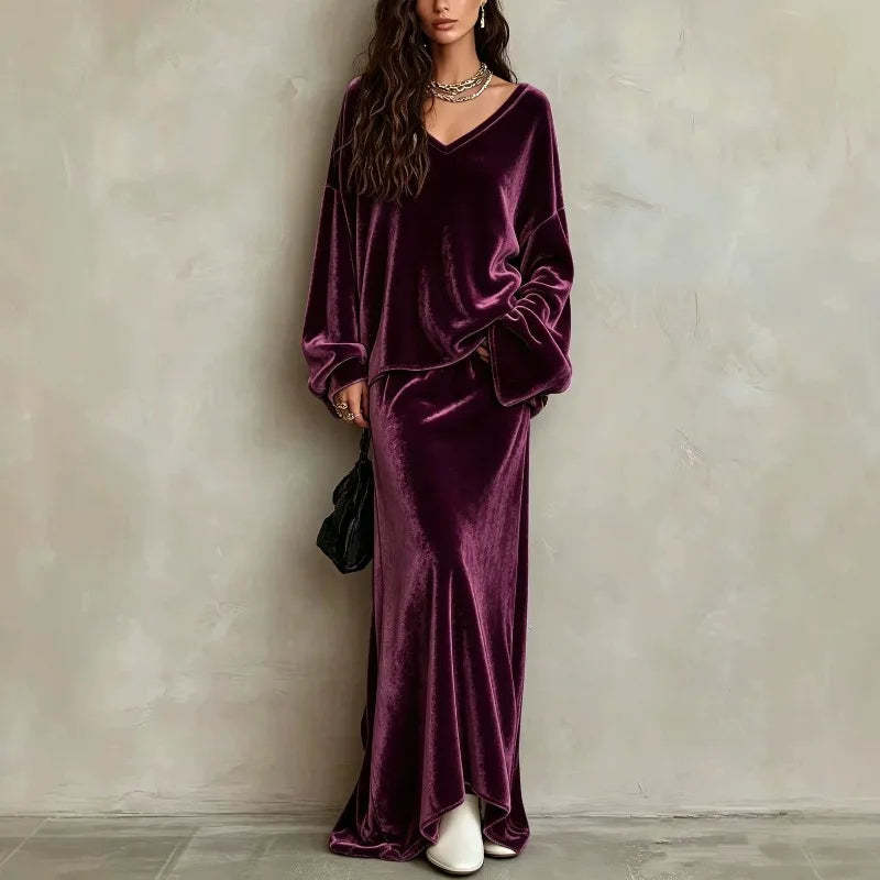 Woman wearing purple velvet V neck pullover and matching maxi skirt set