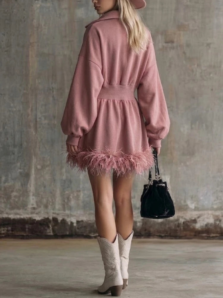 Pink half-zip sweatshirt mini dress with feather trim hem, back view