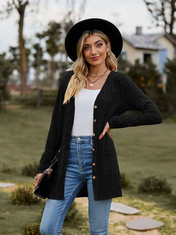 Woman in black hat wearing black ribbed knit cardigan