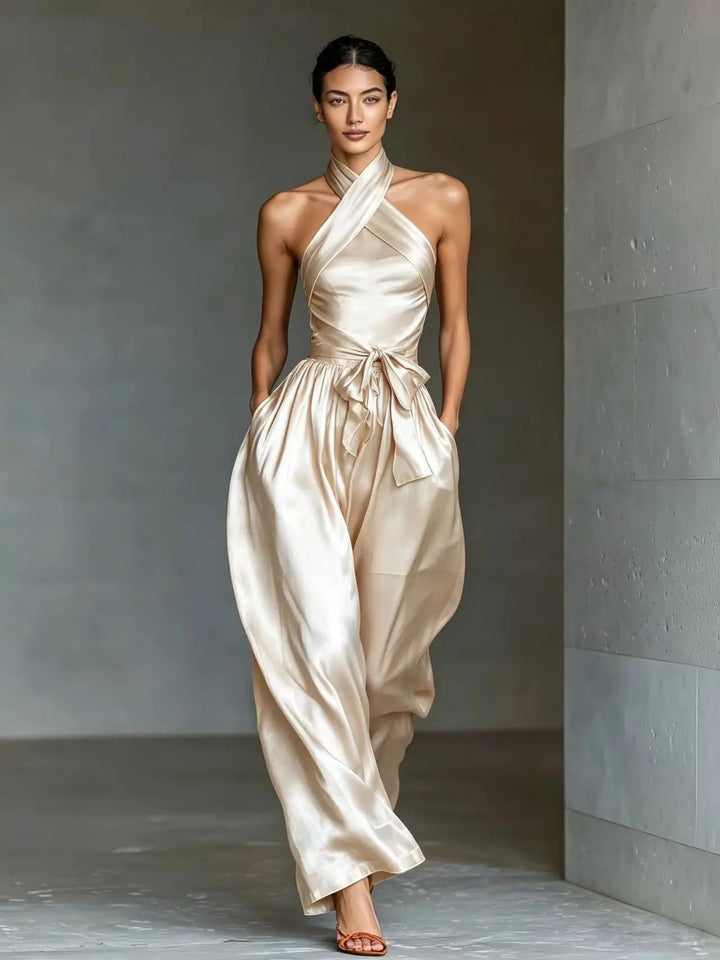 Ivory satin halter jumpsuit with crossed neckline and wide leg