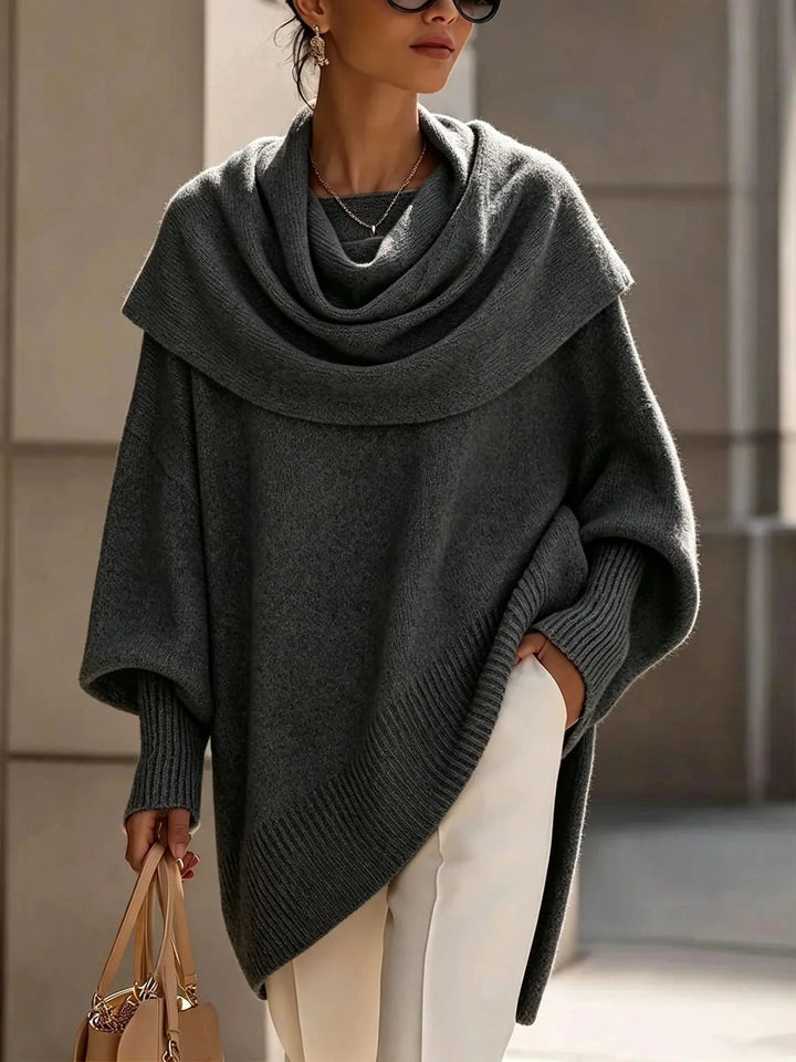 Woman wearing dark grey draped scarf collar poncho sweater