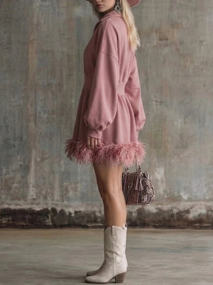 Pink half-zip sweatshirt mini dress with feather trim hem, side view