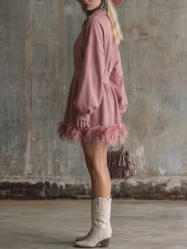 Pink half-zip sweatshirt mini dress with feather trim hem, side view