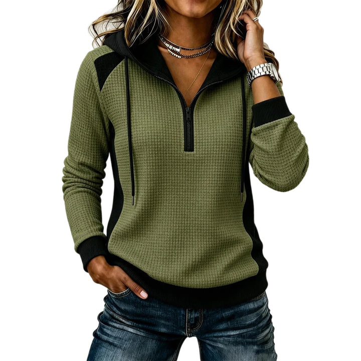 Woman wearing army green waffle knit half zip hoodie with black contrast panels