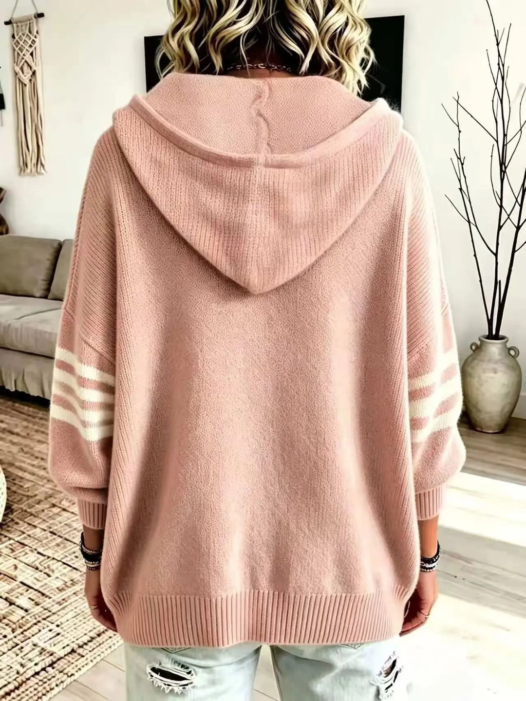 Back view of pink zip-up hoodie showing hood and striped sleeves