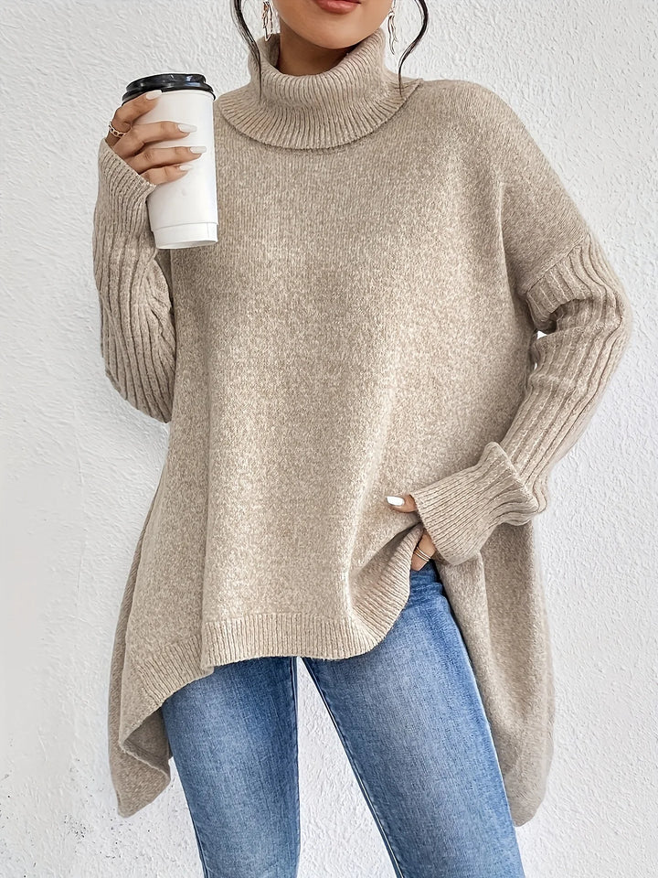 Woman wearing light brown oversized turtleneck sweater with ribbed sleeves