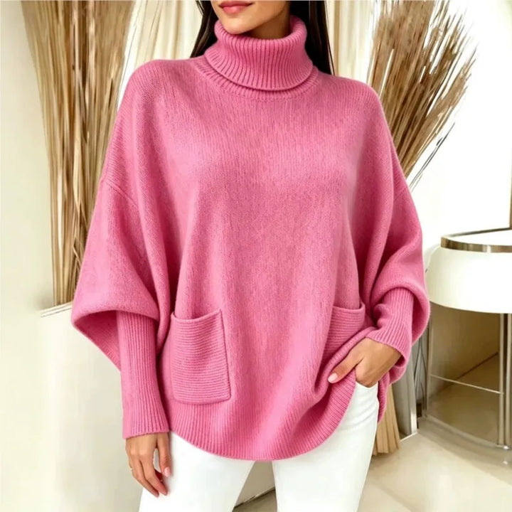 Woman wearing pink turtleneck batwing sweater with front pocket