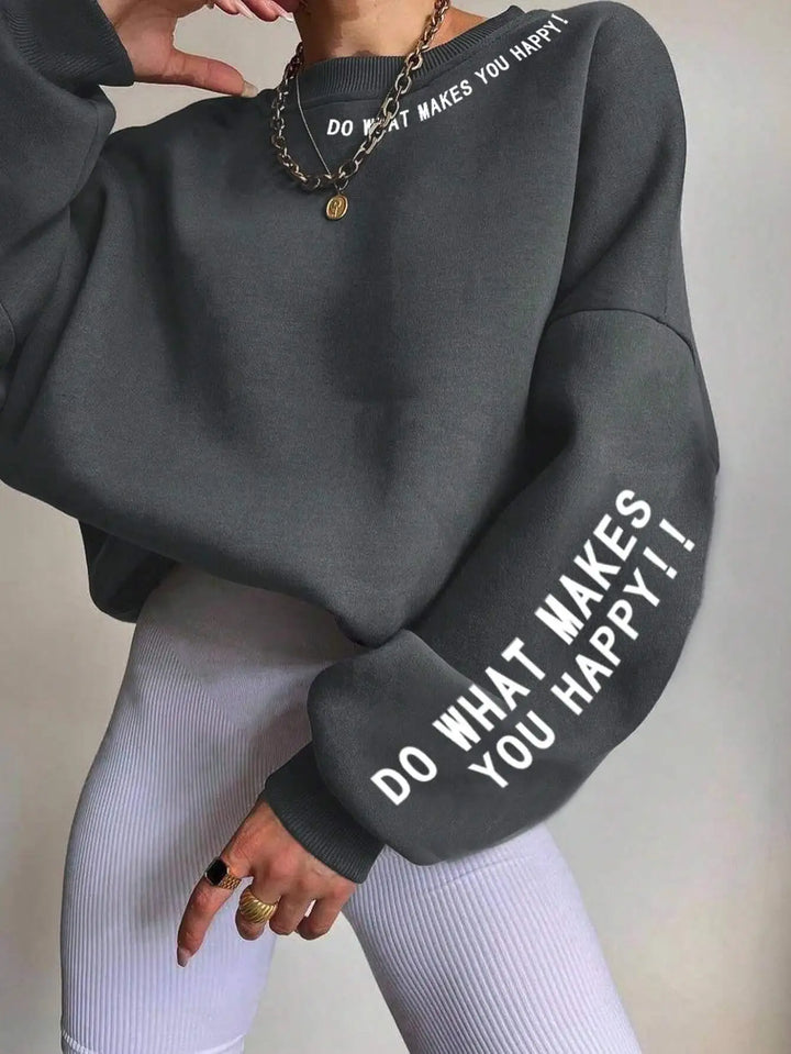 Woman wearing dark gray graphic sweatshirt with sleeve print