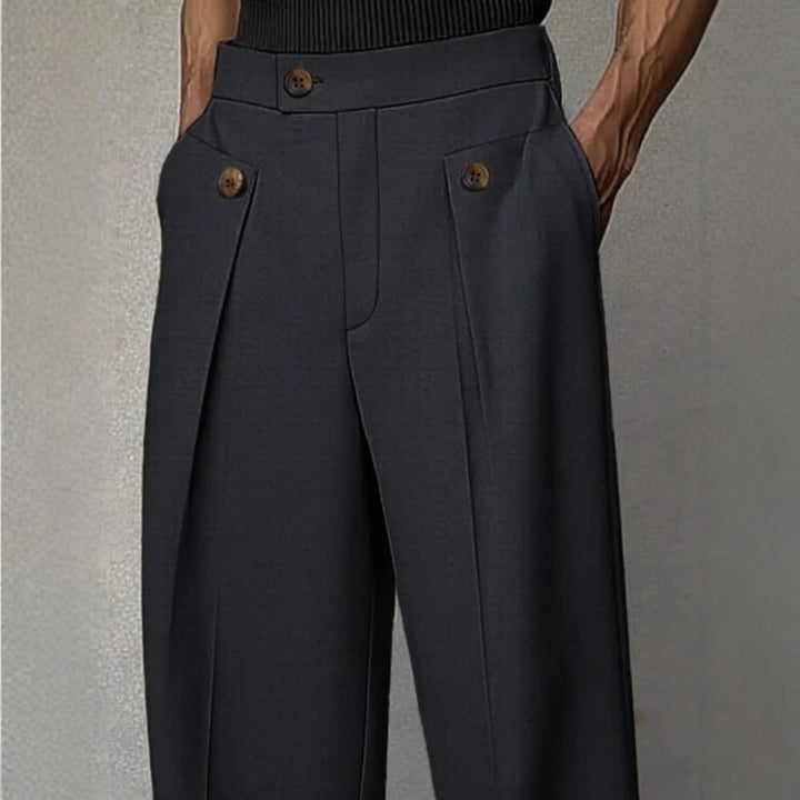 Close view of button tab pocket detail on charcoal trousers