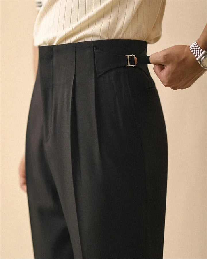 Close up of black trousers with side tab buckle detail